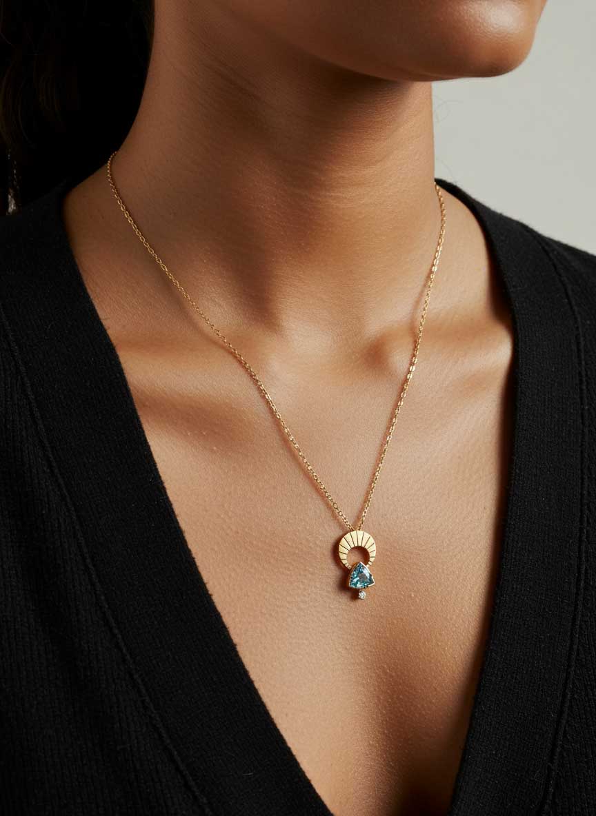 Woman wearing Above and Below gold moon aquamarine and diamond necklace.