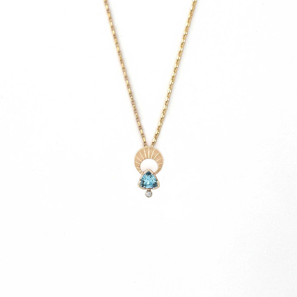 Above and Below necklace in 14k gold with hand-engraved crescent moon, trillion aquamarine and diamond