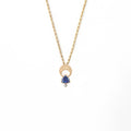 Above and Below necklace in 14k gold with hand-engraved crescent moon, trillion tanzanite, and diamond