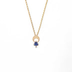 Above and Below necklace in 14k gold with hand-engraved crescent moon, trillion tanzanite, and diamond