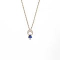 Above and Below necklace in sterling silver with hand-engraved crescent moon, trillion tanzanite, and diamond