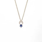 Above and Below necklace in sterling silver with hand-engraved crescent moon, trillion tanzanite, and diamond