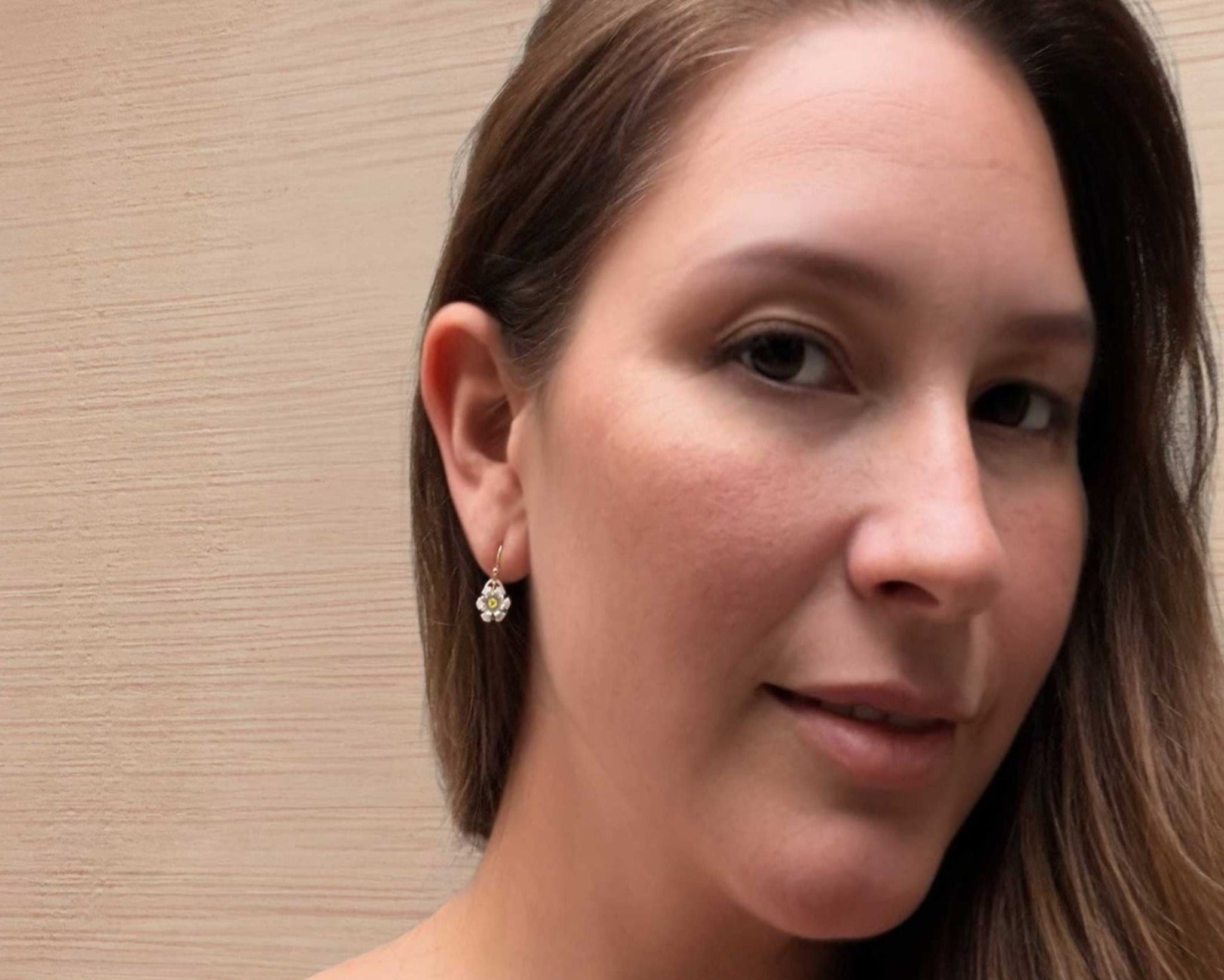 Woman wearing Blossom drop silver earrings with gold ear wires and yellow sapphires