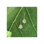 Blossom dangle earrings with matte white silver petals and 1.7 mm diamond, gold filled ear wires, on leaf