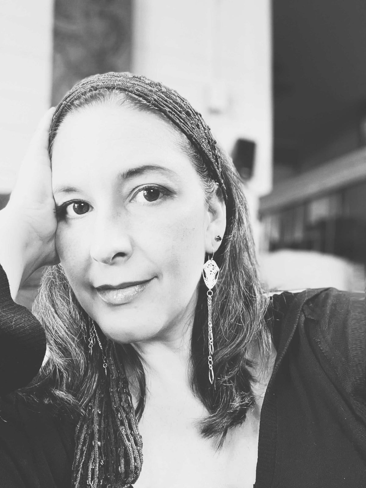 Black and white photo of Camille wearing the Cocoon Chandelier Earrings | Camille Torres Designs