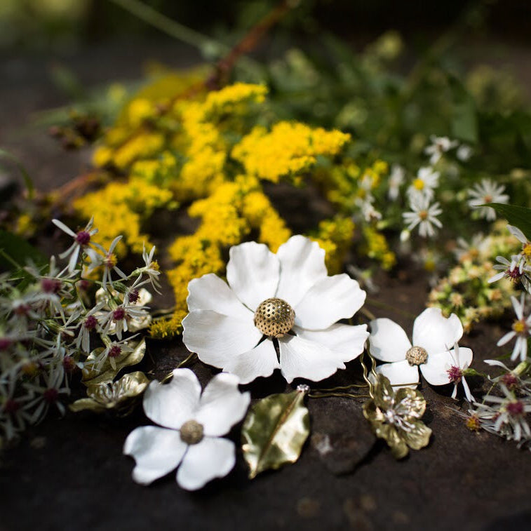 Custom silver flower wedding hair combs in a garden