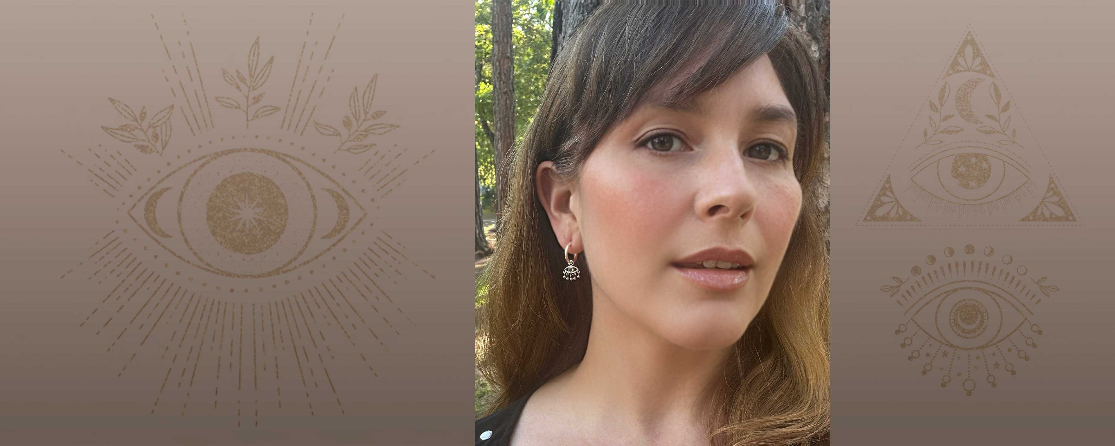 Evil Eye charm hoop earrings worn by model