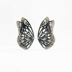 Flight monarch butterfly oxidized silver ear climber with diamonds on a white background