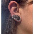 Close up of patina silver butterfly ear climber with silver edge. 
