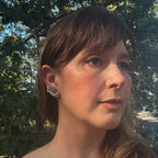 Woman  wearing Flight oxidized silver butterfly ear climbers  standing outdoors with trees in the background
