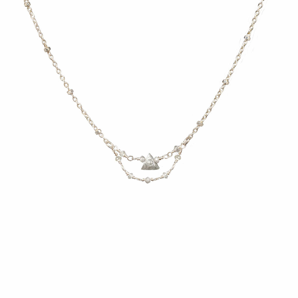 Grey Dawn silver necklace with a 4 mm raw grey triangle diamond pendant on a white background