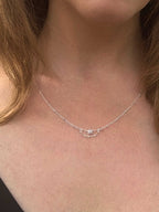 Close-up of a Grey Dawn silver and raw diamond necklace on a person's neck