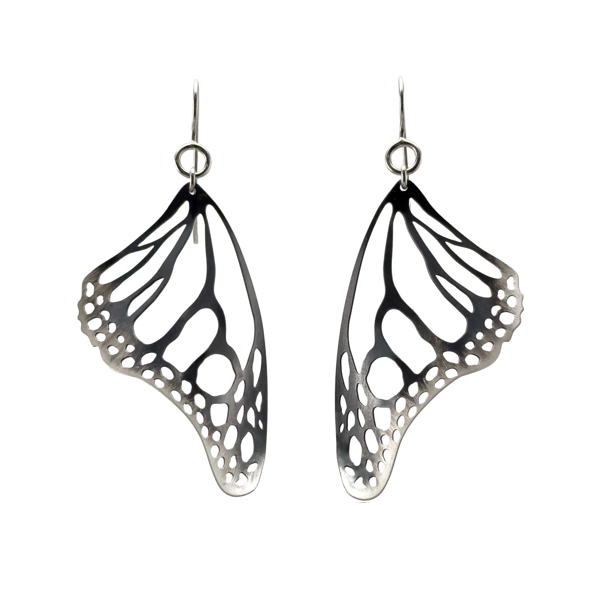 Monarch butterfly wing-shaped black and silver earrings on a white background