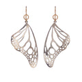 Pair of silver Monarch butterfly wing earrings on a white background