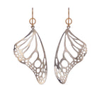 Pair of silver Monarch butterfly wing earrings on a white background