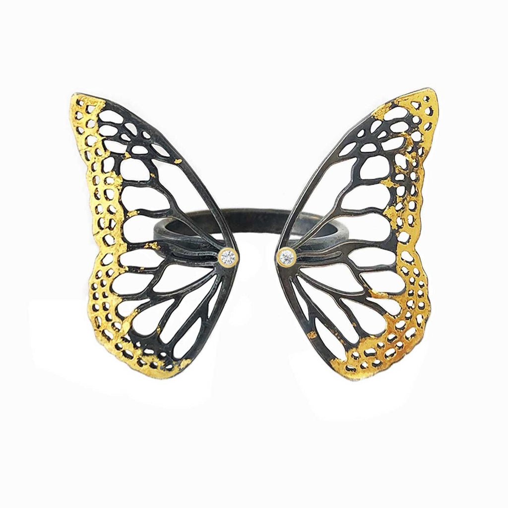 Migration adjustable mixed metal ring with 24k gold 14k gold and silver with diamond accent over a white background. 