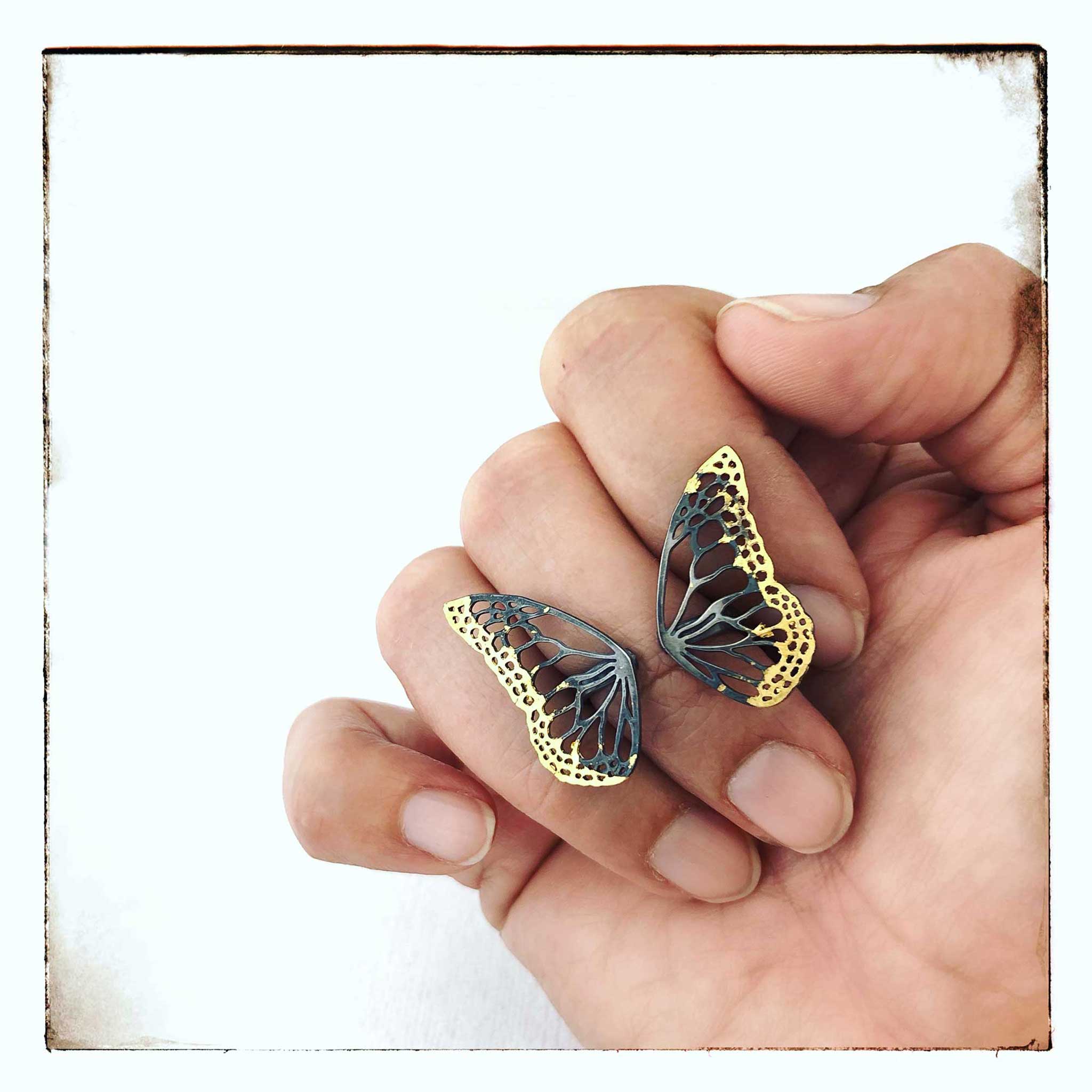 Migration Keum-boo butterfly ring with 24K gold accents on hand, front view showing dimensional wing design