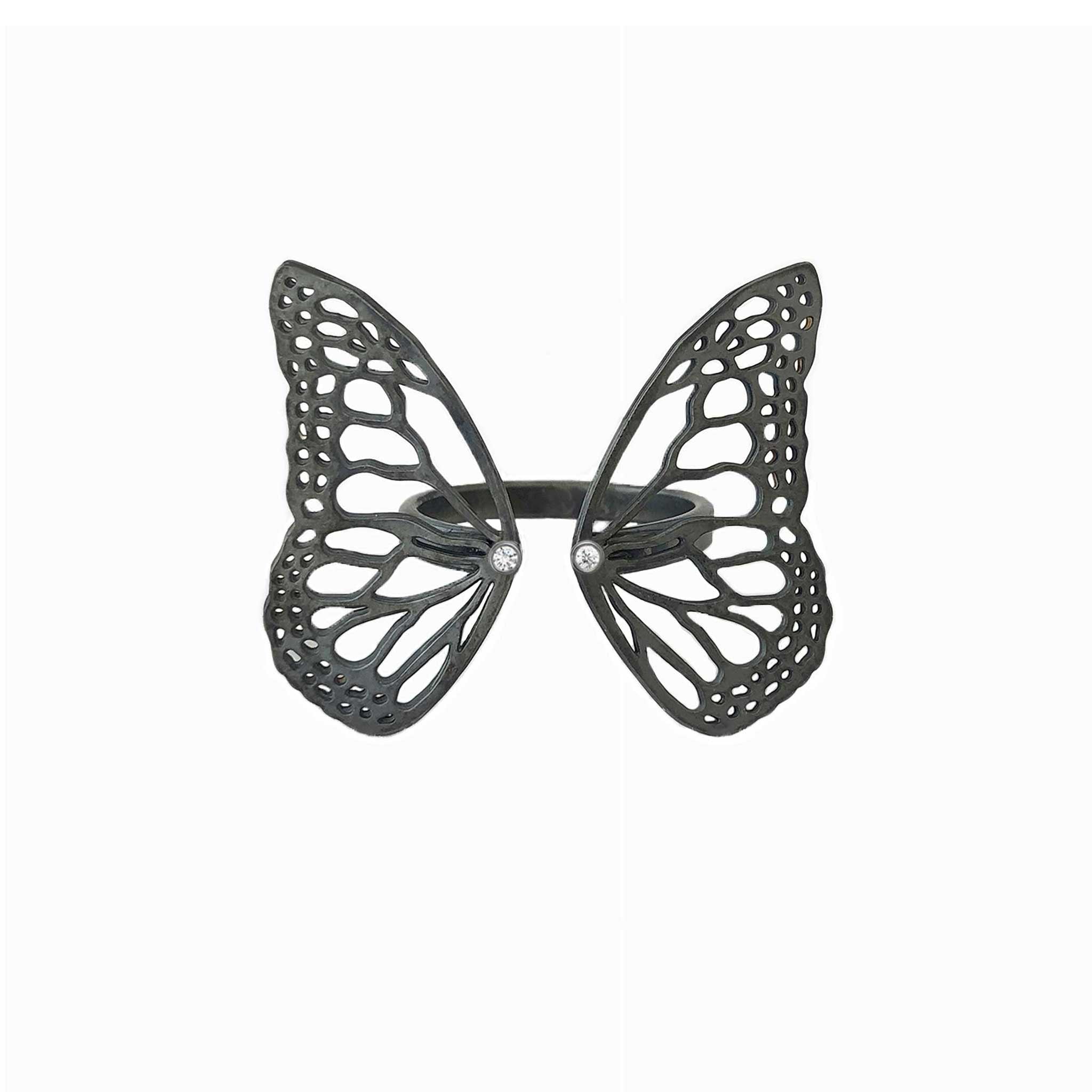 Black oxidized sterling silver butterfly-shaped ring with diamonds on a white background