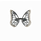 Migration butterfly ring in oxidized sterling silver with intricate cutout wing pattern, 1-inch adjustable band and Diamond accents over a white background | Camille Torres Designs