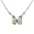 Butterfly necklace with mixed metal gold and black design on a white background