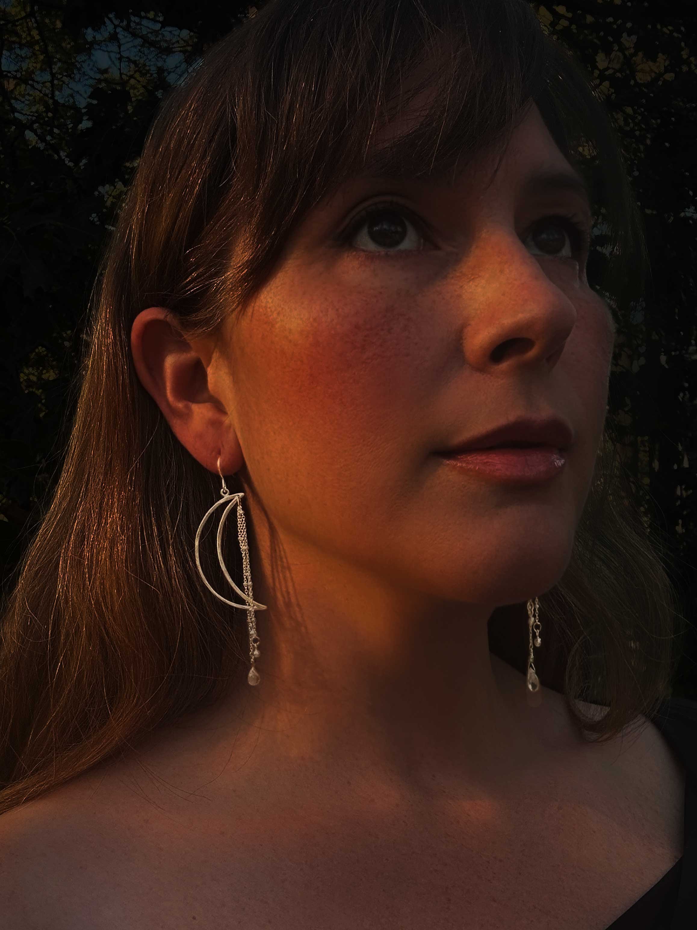 Moon Ray chandelier earrings with radiating design and quartz briolette drops worn on model, 3-inch length