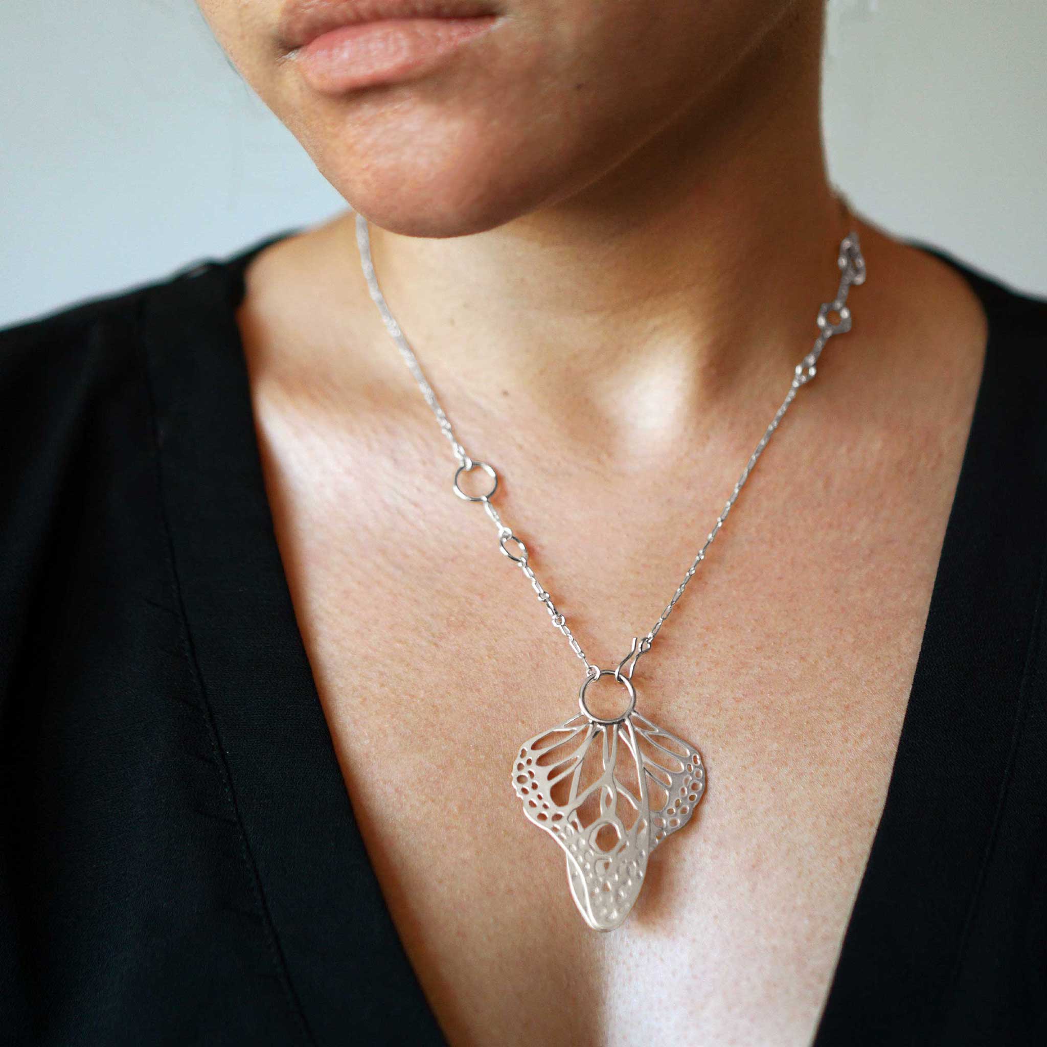 Silver Metamorphosis butterfly wing lariat necklace worn by a model