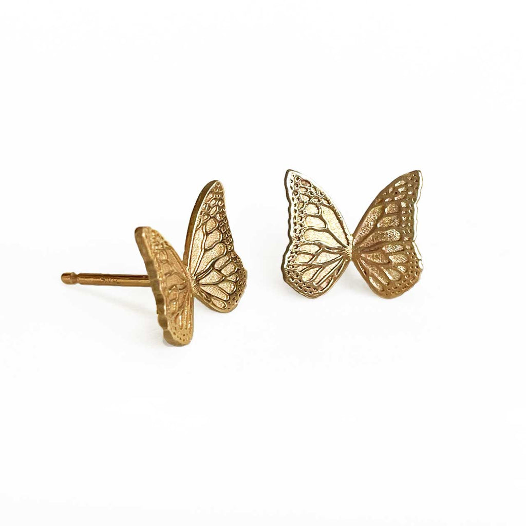 Gold Whisper butterfly stud earrings on a white background