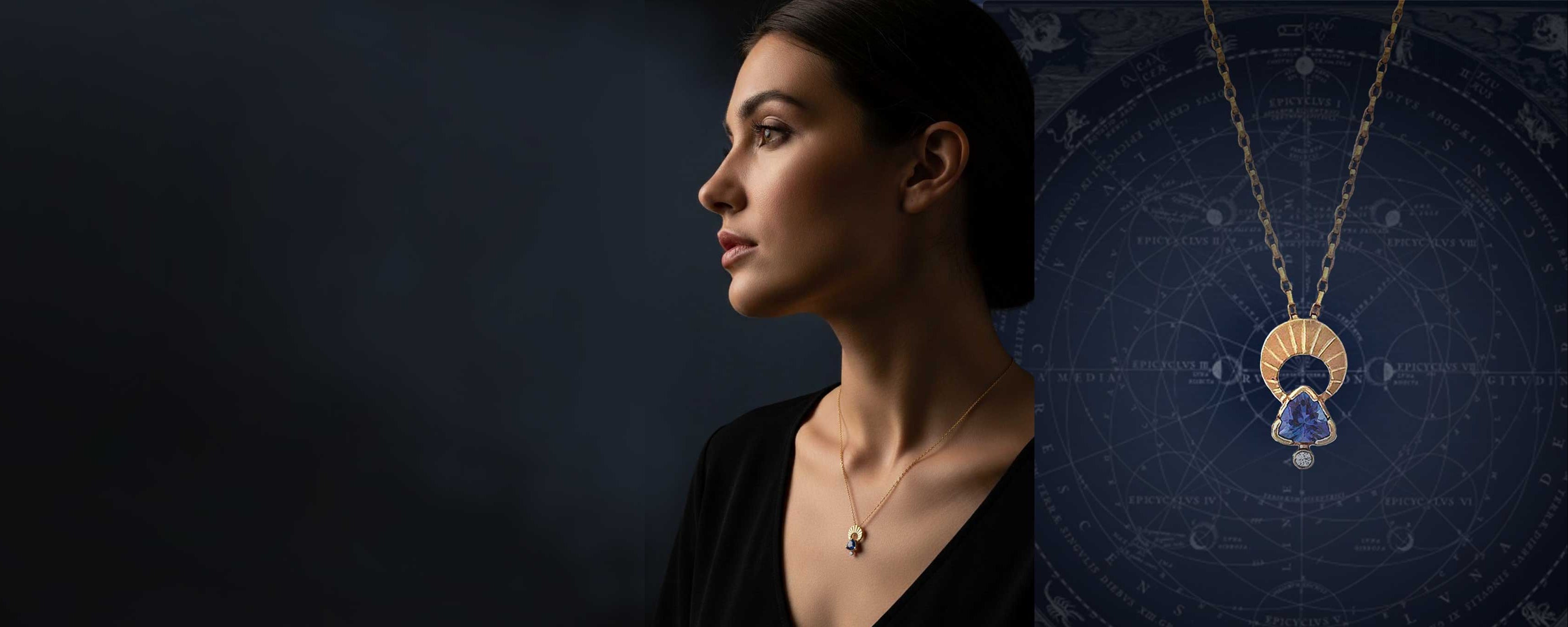 Woman wearing a necklace with a above and Below gold tanzanite moon pendant against a dark background
