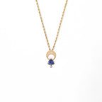 14k Gold Moon necklace with a trillion tanzanite and diamond on a white background | Camille Torres Designs