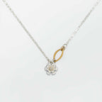 Flower pendant mixed metal necklace with a silver floral pendant and a diamond center set in gold on a white background | Camille Torres Designs