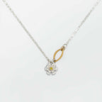 Flower charm necklace with a floral pendant and a gold and sapphire center on a white background | Camille Torres Designs