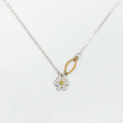 Flower charm necklace with a floral pendant and a gold and sapphire center on a white background | Camille Torres Designs