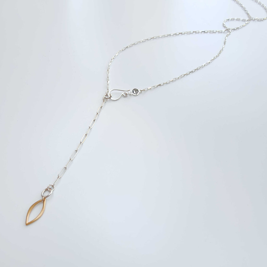 Blossom silver and vermeil necklace hook clasp with a gold marquise charm at the end of a 2 inch extension on a white surface | Camille Torres Designs