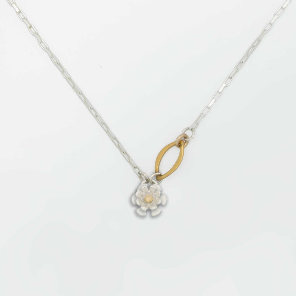 Floral pendant silver necklace with a mixed metal floral pendant and a gold center on a white background | Camille Torres Designs