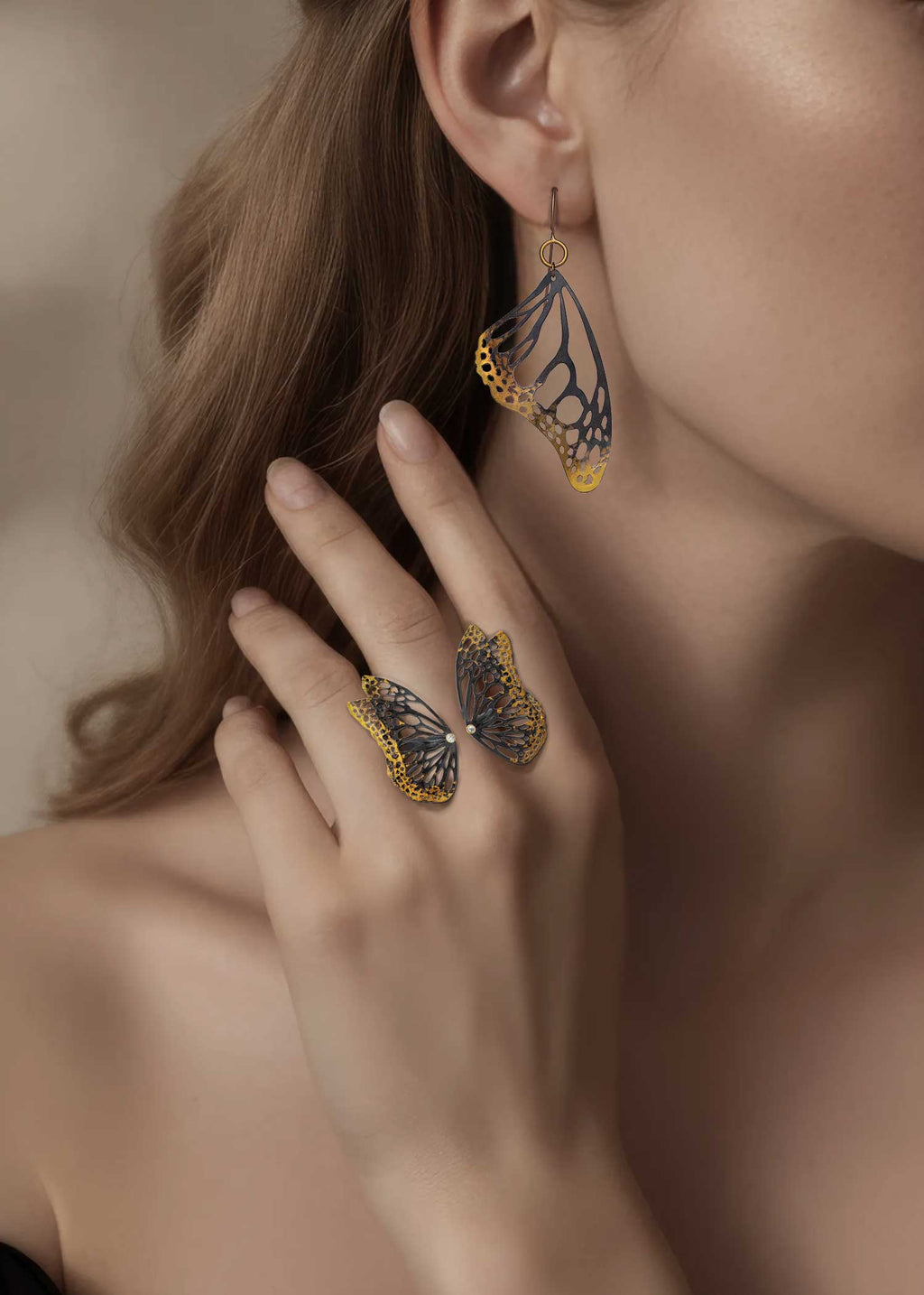 Monarch drop earring paired with Flight diamond adjustable butterfly ring in mixed metal, 24k gold and oxidized sterling silver on a woman.