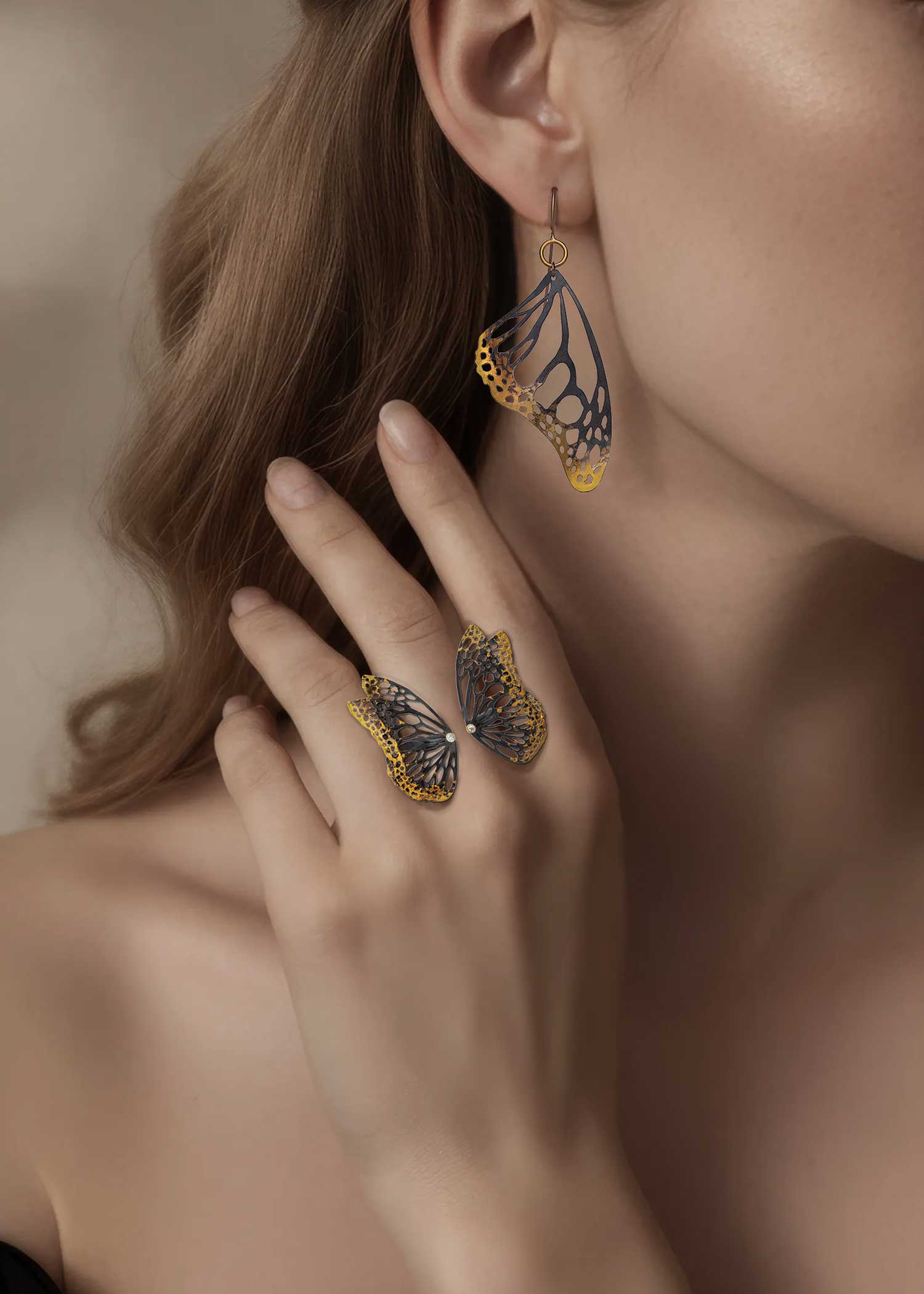 Monarch drop earring paired with Flight diamond adjustable butterfly ring in mixed metal, 24k gold and oxidized sterling silver on a woman.
