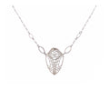 Cocoon butterfly wing pendant necklace handcrafted in sterling silver on a white background | Camille Torres Designs