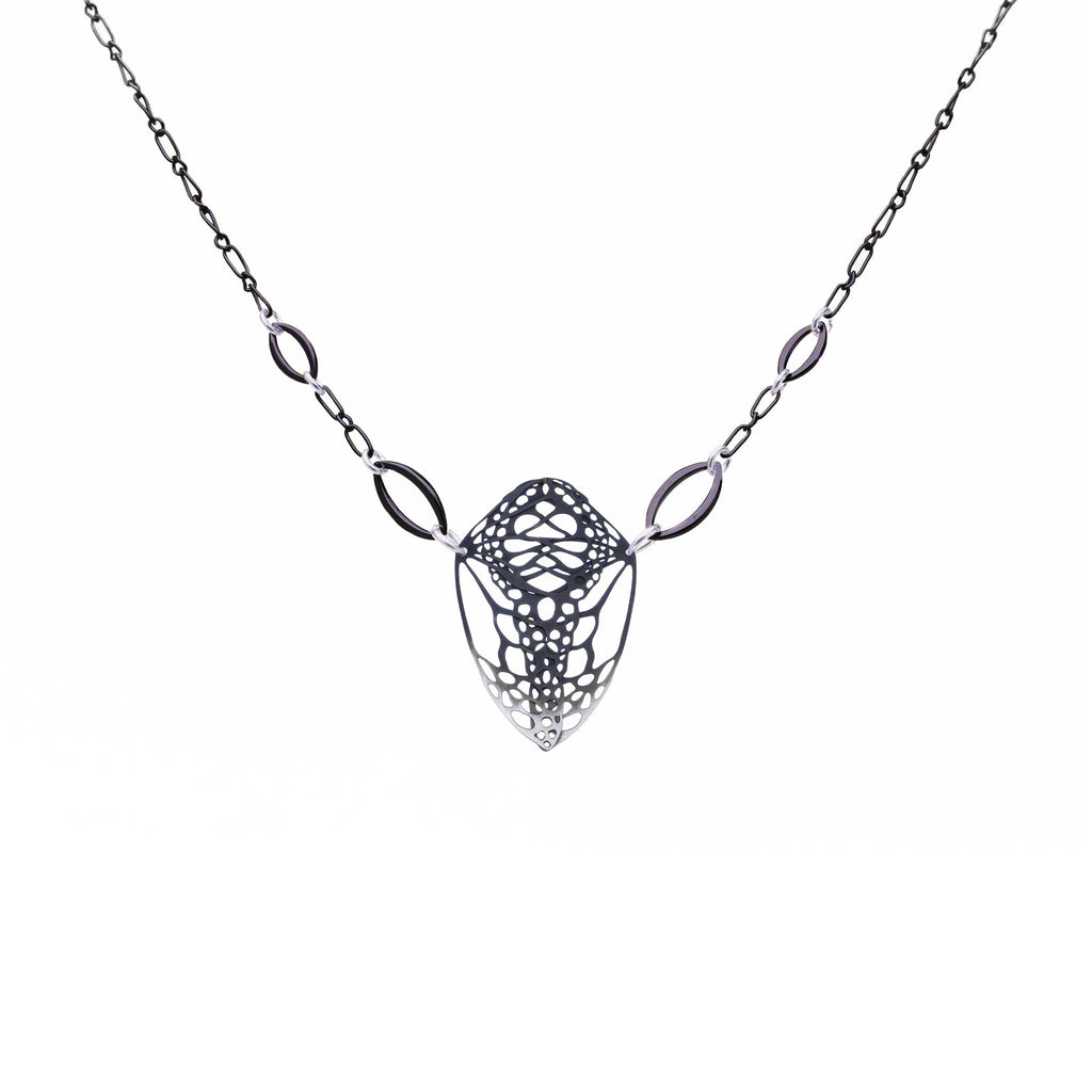 Cocoon monarch butterfly pendant necklace in oxidized silver on a white background | Camille Torres Designs