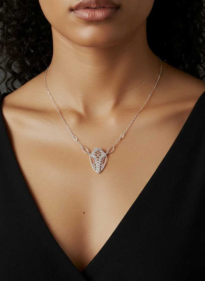 Cocoon monarch pendant silver necklace worn by a person against a dark background
