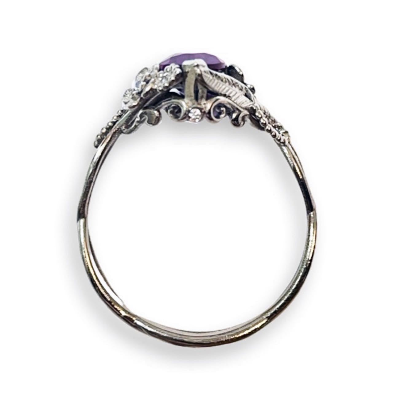 bridge view of custom floral engagement ring with a colored marquise gem in white gold and diamond accents over a white background | Camille Torres Designs