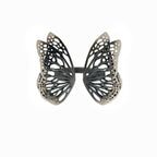 Flight butterfly ring in oxidized sterling silver with intricate cutout wing pattern, 1-inch adjustable band over a white background | Camille Torres Designs