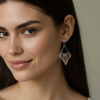 Woman wearing silver Flutter butterfly earrings and a neutral background