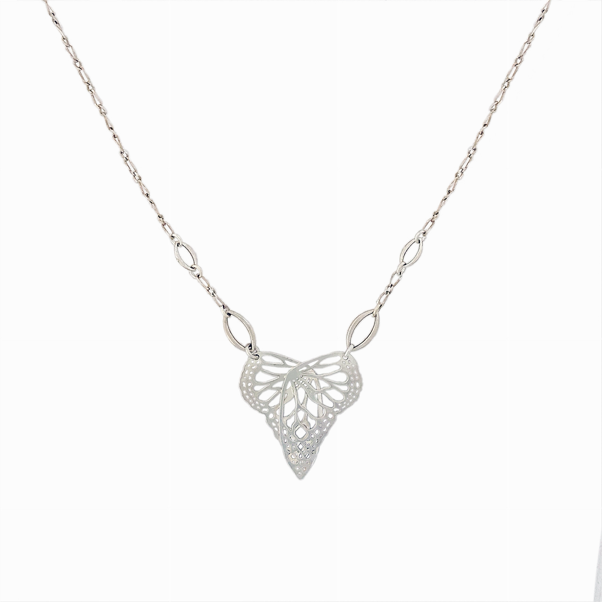 Silver Flutter Butterfly in a heart shaped handcrafted pendant on a chain against a white background | Camille Torres Designs
