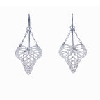 Pair of handcrafted silver heart-shaped butterfly drop earrings suspended from delicate chain on a white background | Camille Torres Designs