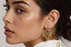 Woman wearing handmade butterfly mixed metal keum-boo drop earrings with 14k gold and diamonds 
