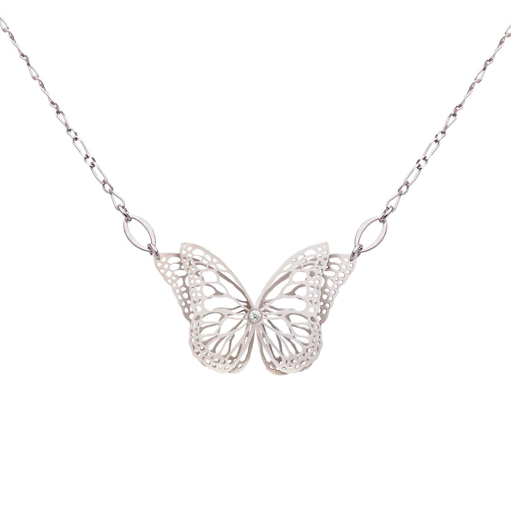 The Migration bright silver butterfly pendant necklace with diamond center and overlapping, 2 wing design, suspended from a delicate silver chain against a plain white background.
