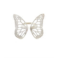 Migration butterfly ring in bright sterling silver with intricate cutout wing pattern, 1-inch adjustable band over a white background | Camille Torres Designs