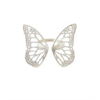 Migration butterfly ring in bright sterling silver with intricate cutout wing pattern, 1-inch adjustable band over a white background | Camille Torres Designs