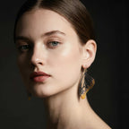 Close up of woman wearing mixed metal  Monarch butterfly earrings with 24k gold and oxidized silver