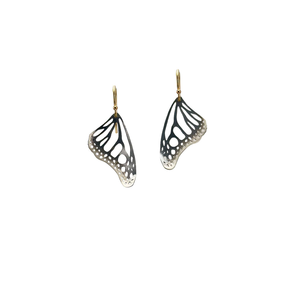 Handmade small Monarch butterfly drop earrings in oxidized silver with 14k gold ear wires over a white background